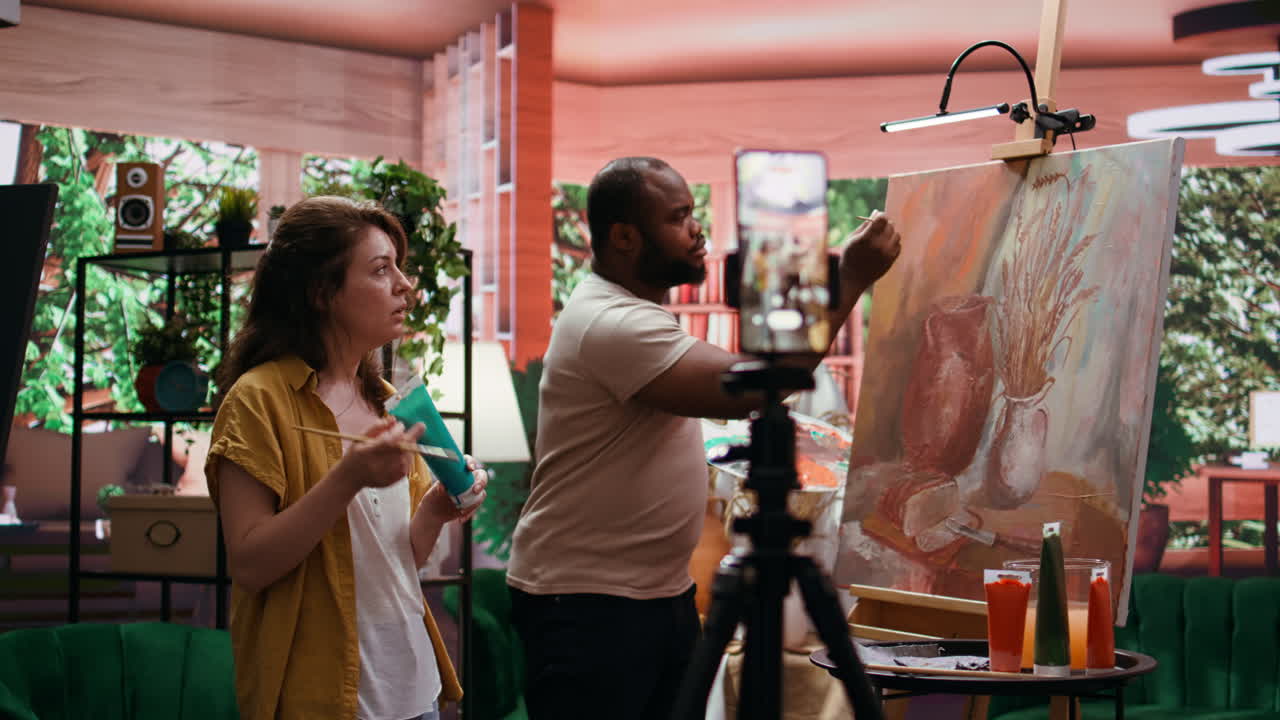 Artists working together on a still life painting in a studio
