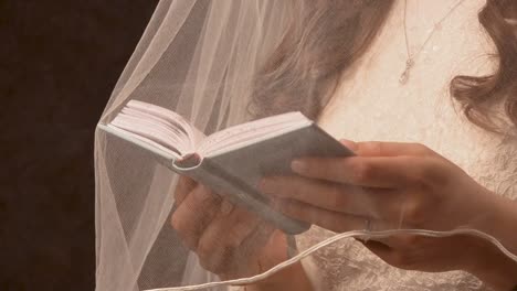 jewish woman reading scripture under her vail