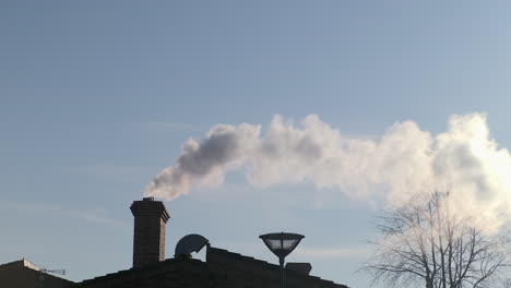 a smoking chimney in nord of france due to cold weather