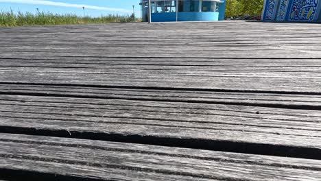 wooden deck with blue barrels and grass