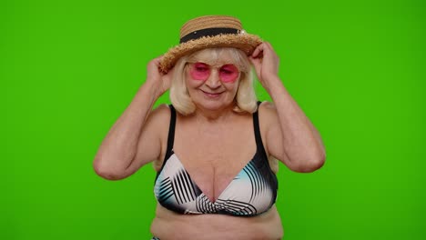 Senior-woman-tourist-in-swimsuit-wearing-hat,-waving-hands-hi-hello-welcome-greetings-on-chroma-key