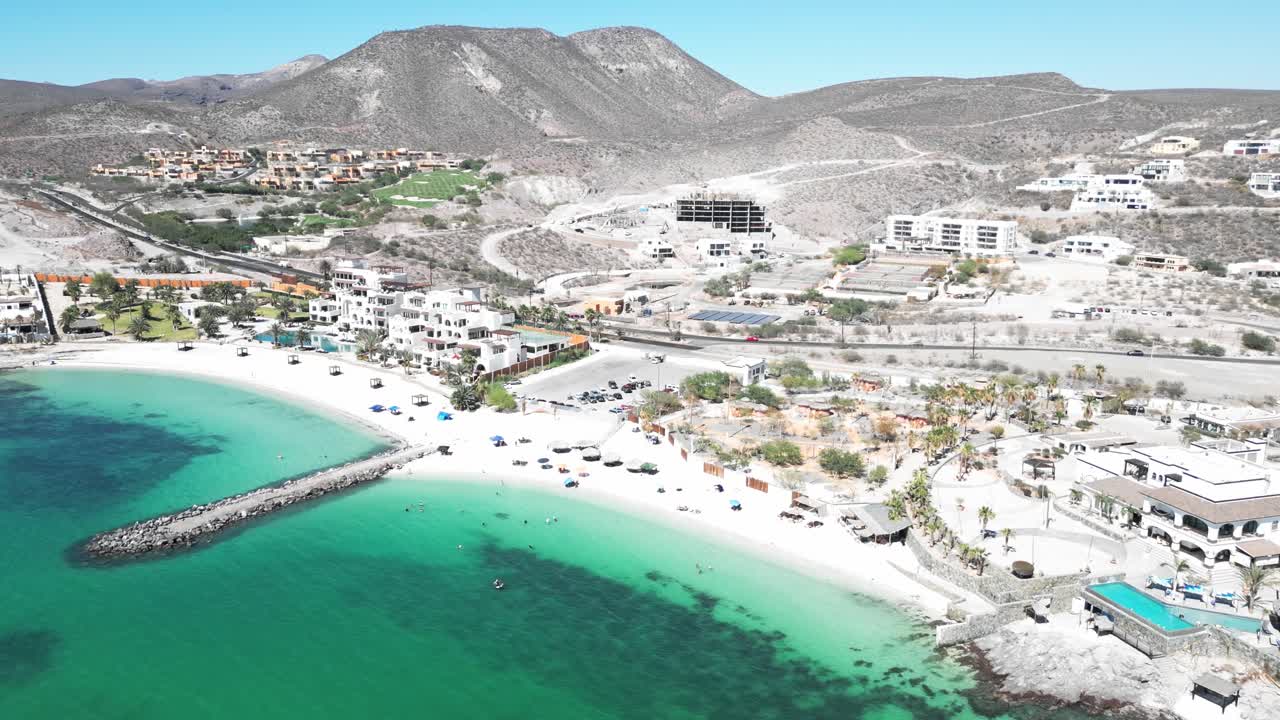 Beachfront hotels and turquoise water at Playa Caymancito, La Paz, Baja California Sur