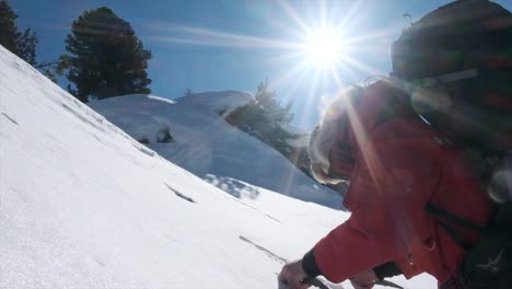 Close-up-of-caucasian-man-using-ice-axes-to-climb-steep-snowy-mountain