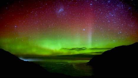 night timelapse shot capturing auroral activity, beautiful southern light aurora illuminate the dark sky, exhibiting vibrant dancing waves of lights at nugget point new zealand during winter