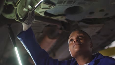 Video-of-african-american-female-car-mechanics-checking-car