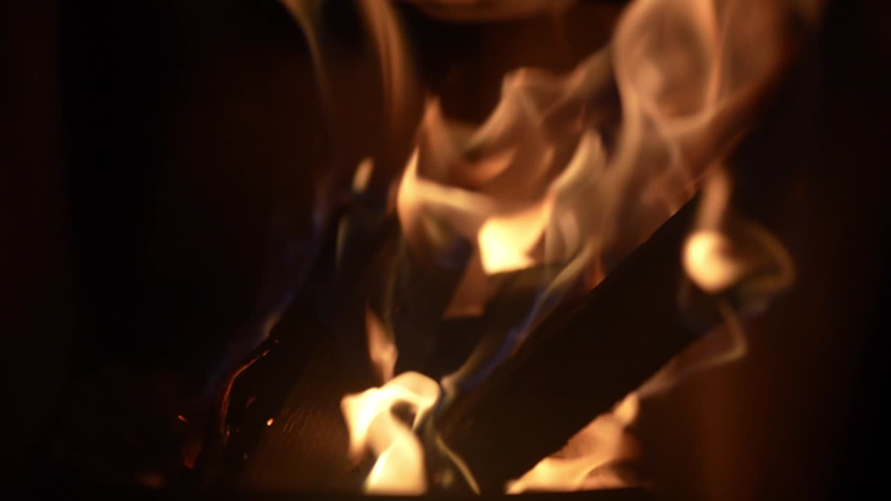 Close-up view of a campfire with burning logs in slow motion