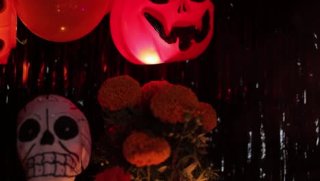 Pumpkin-and-skeleton-decorations-and-cempasuchil-on-candlelit-altar