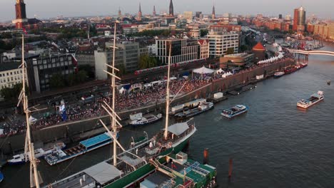 Hamburg-Harbour-Landungsbrücken-at-Hamburg-Cruise-Days-with-subway-riding-through-the-shot-and-ship-Cap-San-Diego,-Michel-and-Elbphilharmonie-in-the-Background