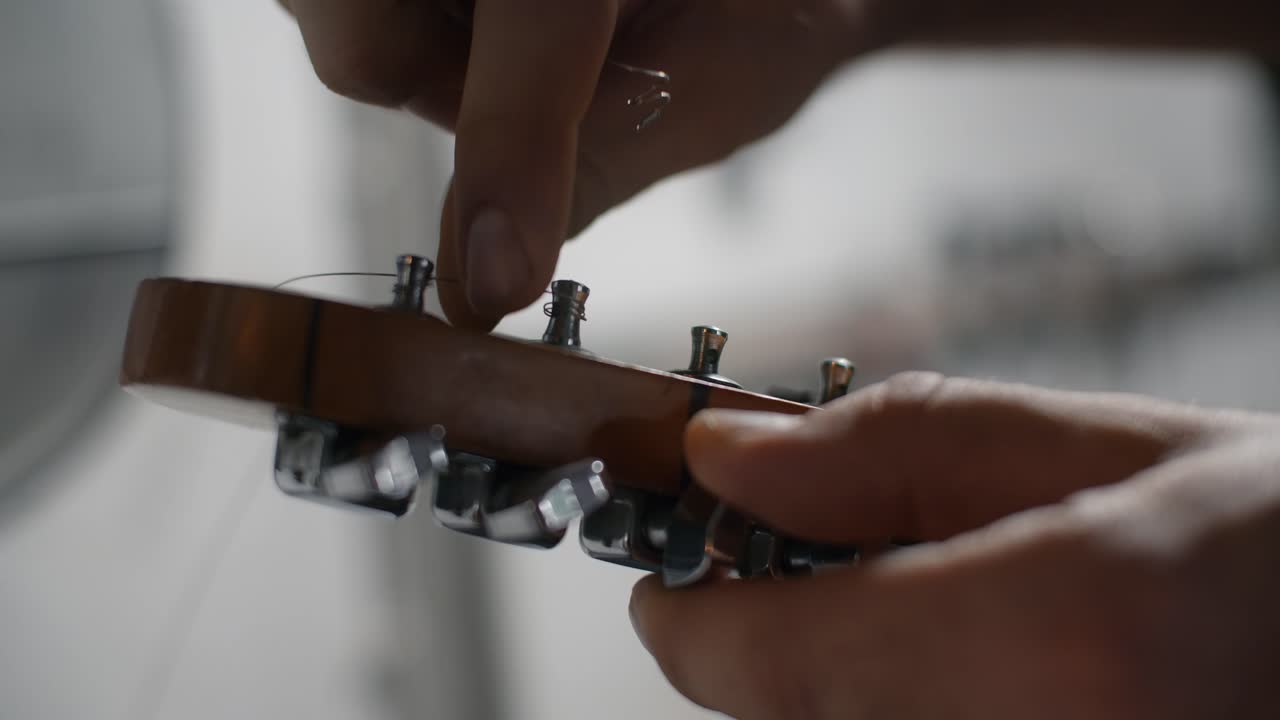 Person Tuning a Guitar