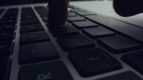 person using laptop computer. man hands typing on black keyboard of laptop