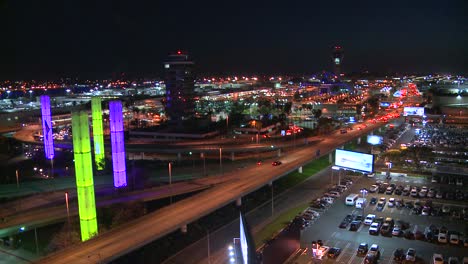 an overview of los angeles international airport at dusk with traffic driving 1