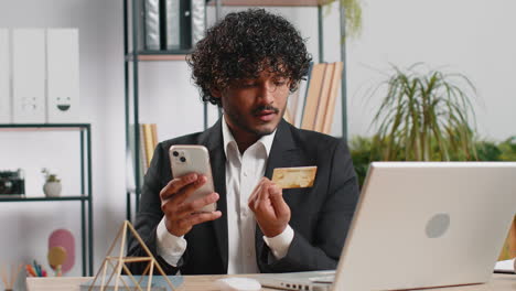 business man making online purchase payment shopping with credit bank card and laptop at office