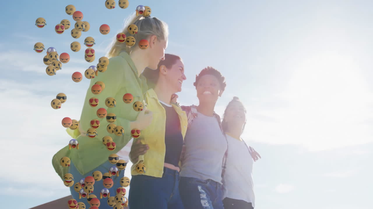 Four women walking arm in arm outdoors, with floating emoji icons adding social media marketing
