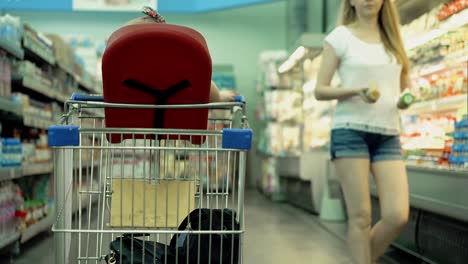 child sits in a specially equipped chair 7 in the supermarket 3