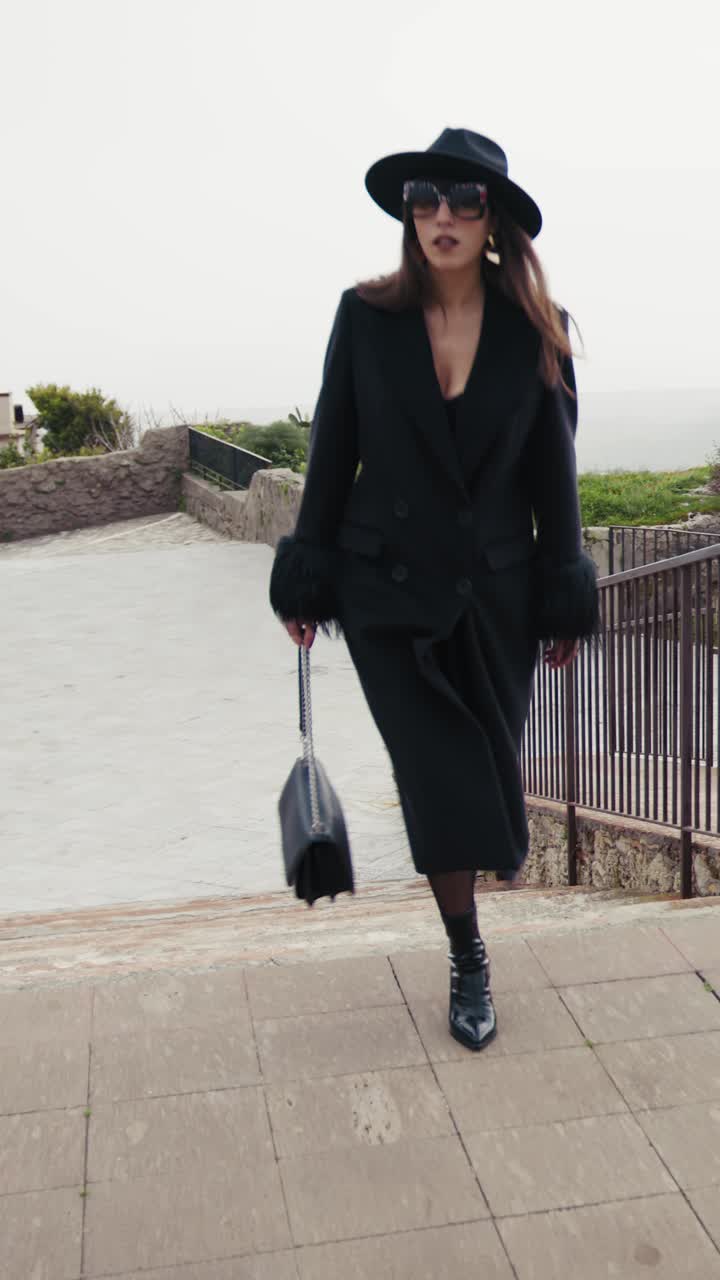 Elegant Model In Total Black Doing A Catwalk In The Small Italian Town