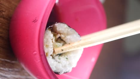 sushi roll with chopsticks