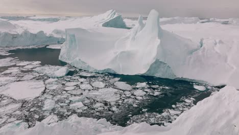 drone over sea and ice of ilulissat icefjord