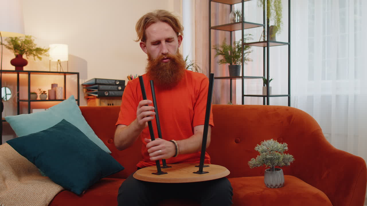 мужчина заканчивает сборку мебели дома в новой квартире, успешно собирает стол, ремонтирует и фиксирует