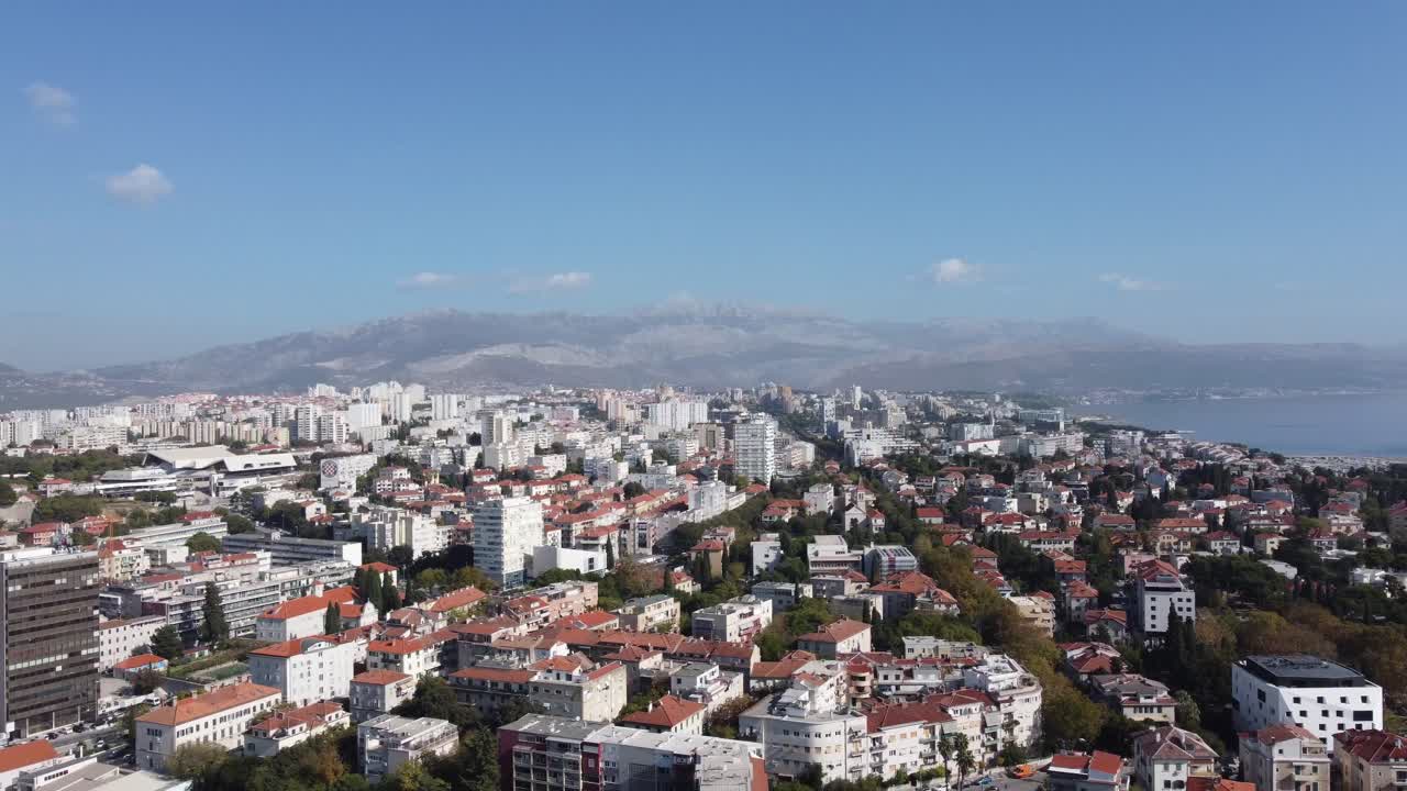 Aerial view of the city of Split on the Adriatic Sea from a panoramic perspective, with its medieval buildings and port with ferries on a sunny summer day. Split, Croatia.