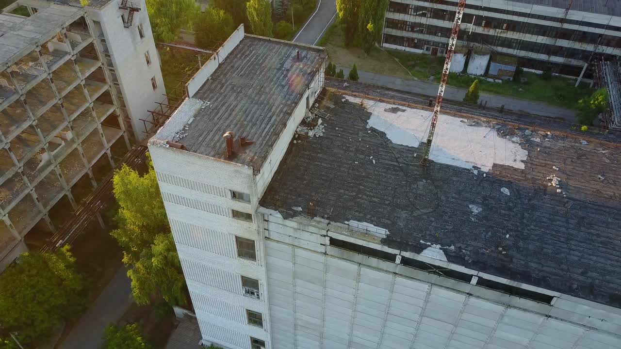 Abandoned Old Buildings. Aerial view of the ruins of an old abandoned factory near farmland