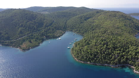 aerial: slow panning drone shot of beautiful panormos bay in skopelos island, sporades, greece