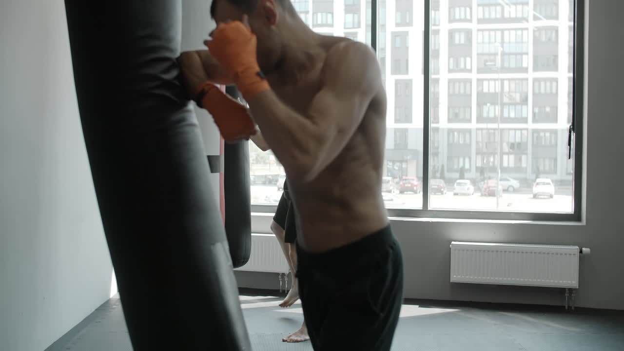 Boxers Training with Punching Bags