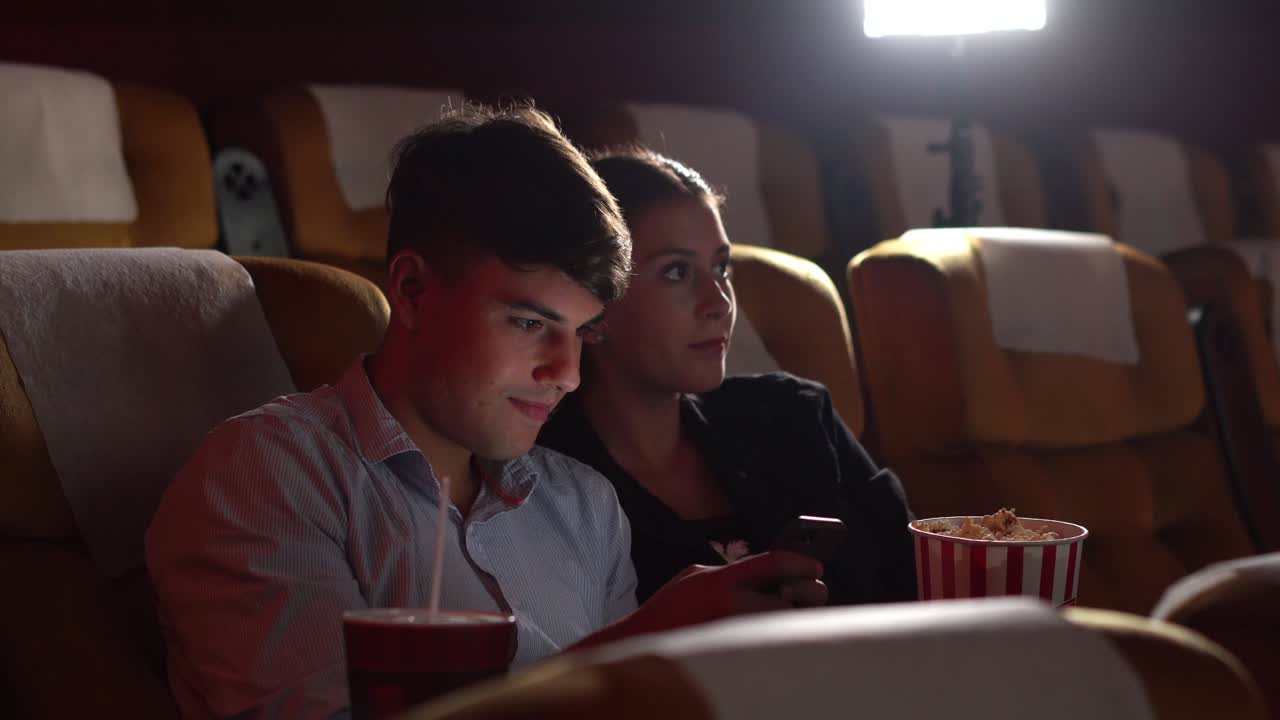 남자들이  ⁇ 드폰으로 게임을 하고 있습니다.