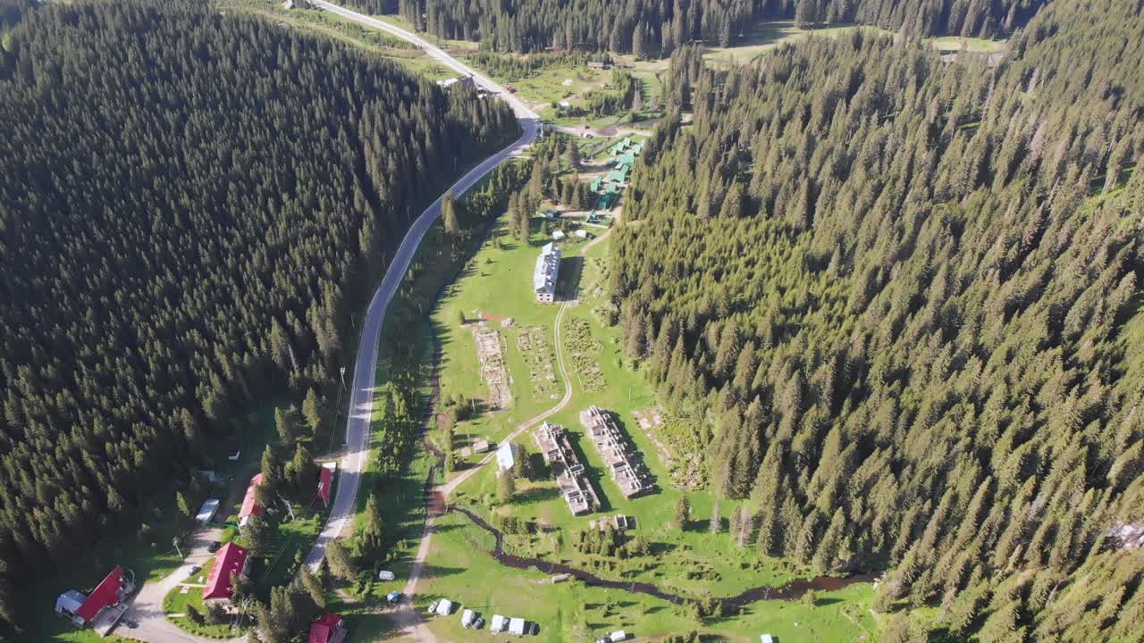Aerial drone shot above houses in Bucegi Mountains, Romania