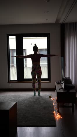 woman stretching by the window