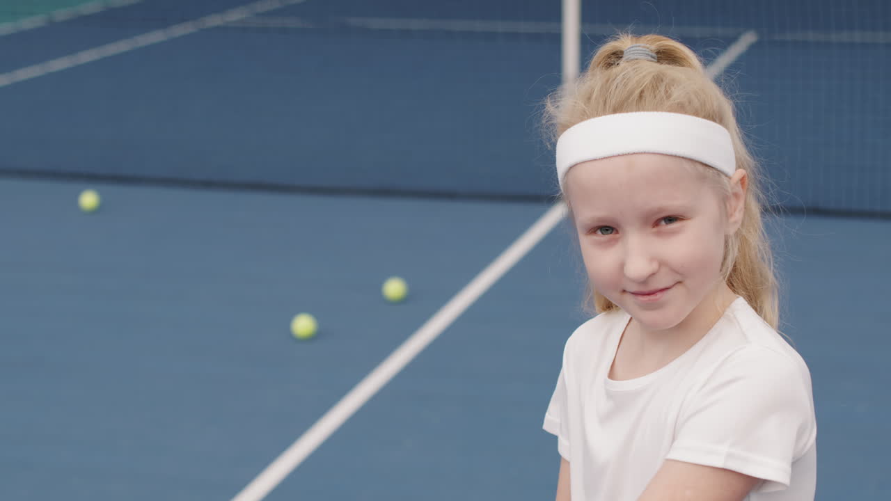 Cheerful Little Girl On Tennis Training