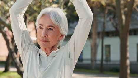 older woman stretching outdoors in a park