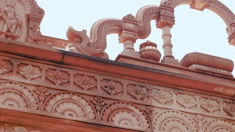 artistic-hand-carved-red-stone-jain-temple-at-morning-from-unique-angle-video-is-taken-at-Shri-Digamber-Jain-Gyanoday-Tirth-Kshetra,-Nareli-Jain-Mandir,-Ajmer,-Rajasthan,-India