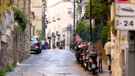 people and vehicles on a narrow street