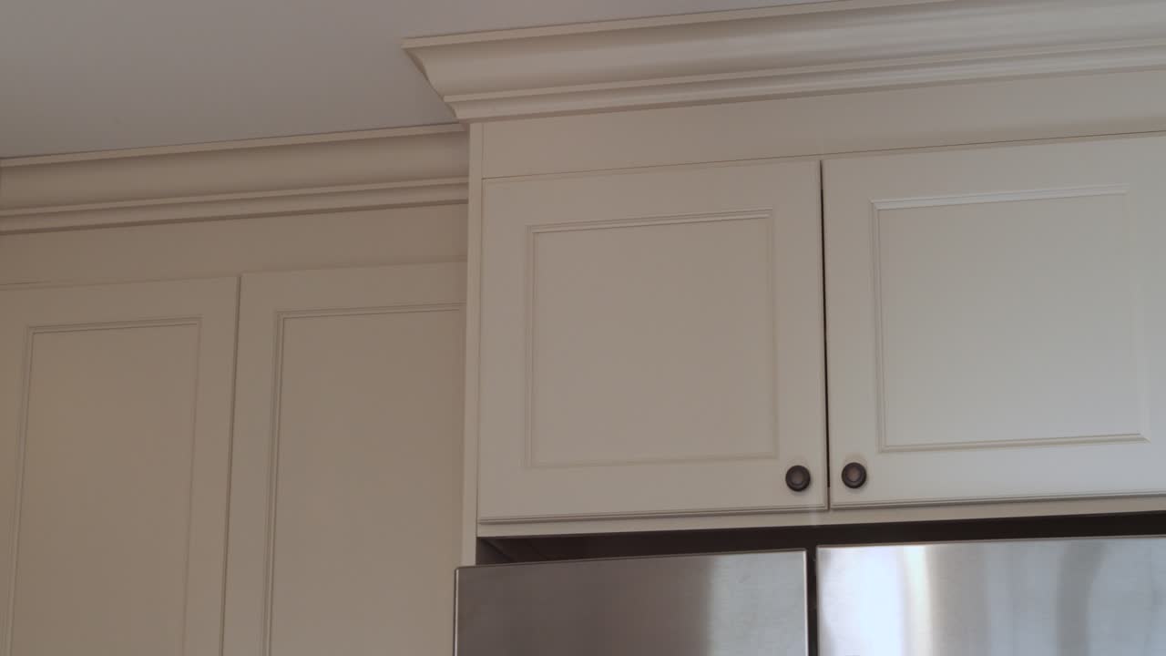 Right to left pan showing moulding detail of newly modernized kitchen.