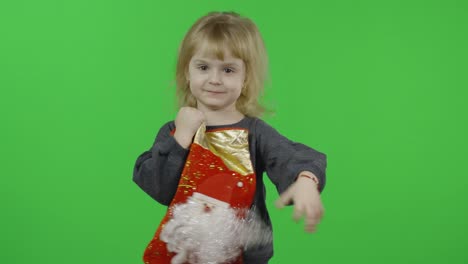 happy beautiful little girl in a sweater with a snowman. christmas. chroma key
