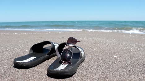 slipper and glasses in sunyy beach