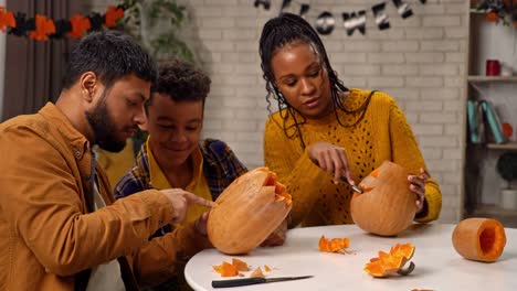 family carving pumpkins for halloween