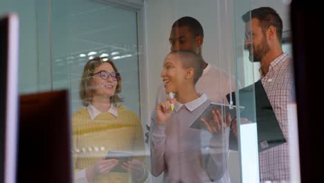 young mixed race business team discussing over glass board in modern office 4k