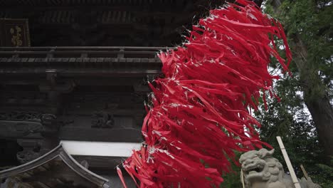 red streamers from sagicho matsuri celebrations at hachiman shrine, blowing in wind