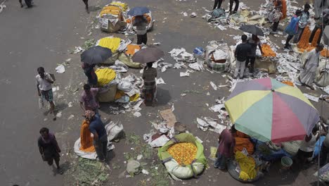 overhead view of a bustling outdoor flower market in india
