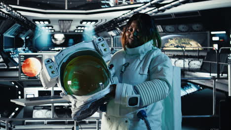 portrait of cheerful astronaut holding helmet inside high tech spacecraft