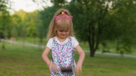 child girl kid loses on mobile phone game, use squishy silicone anti-stress pop it toy to calm down