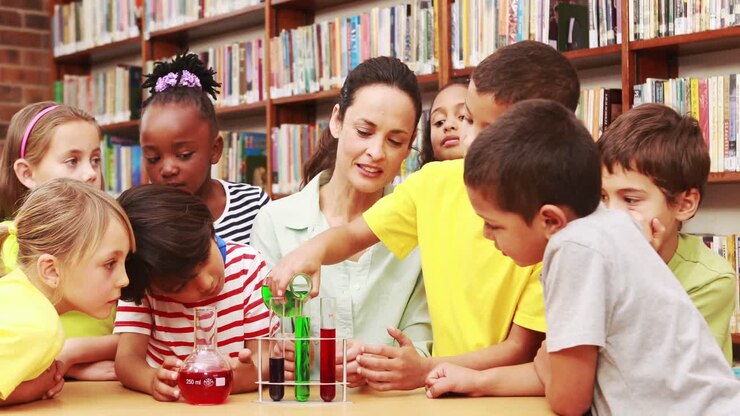 Pupils and teacher doing science in library