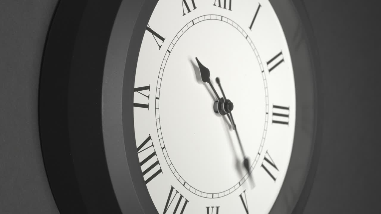 Latin Clock Face in Time Lapse on Dark Grey Wall