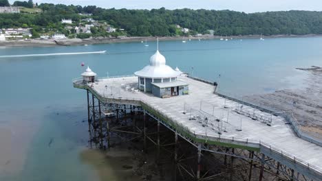 bangor seaside pier north wales silver spire pavilion low tide aerial view low right dolly above platform