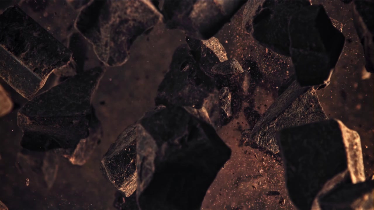 Delicious Dark Chocolate Chunks and Powder Falling in Slow Motion