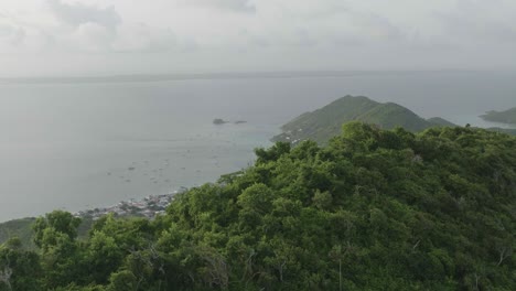 Reveal-of-Grand-Case-Beach-at-Saint-Martin-with-green-mountain-in-foreground-in-Carribean-Island