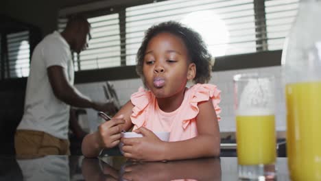 video of african american father and daughter preparing breakfast