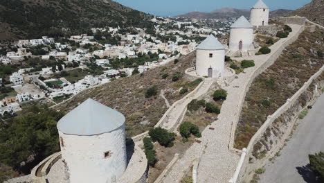 Greece,Leros Island,Drone Footage of the famous windmills of the Island, focusing primarily on the windmills, starting from the top of the hill and zooming out slowly and capturing 5 mills at the end