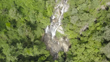A-falling-drone-shot-of-a-waterfall-found-in-the-middle-of-the-jungle-in-thailand